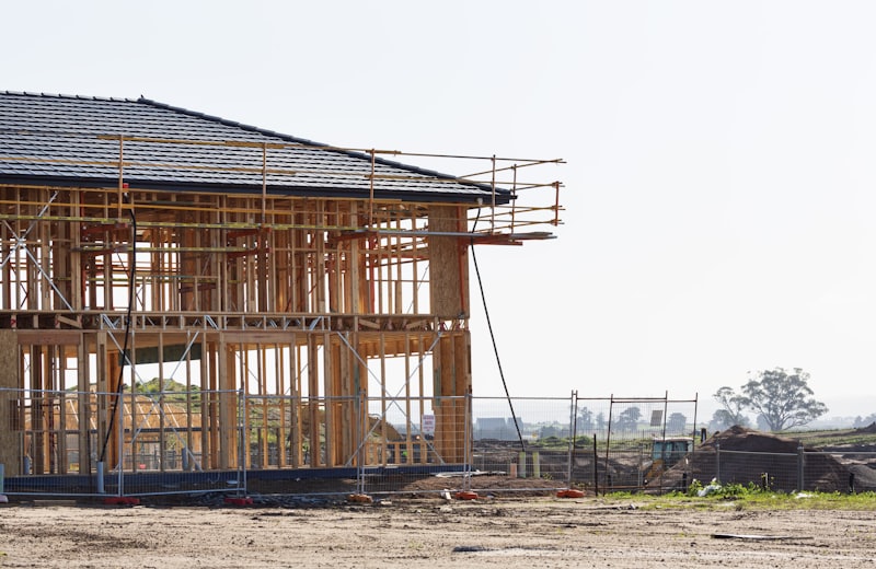 New home under construction with wood framing and scaffolding