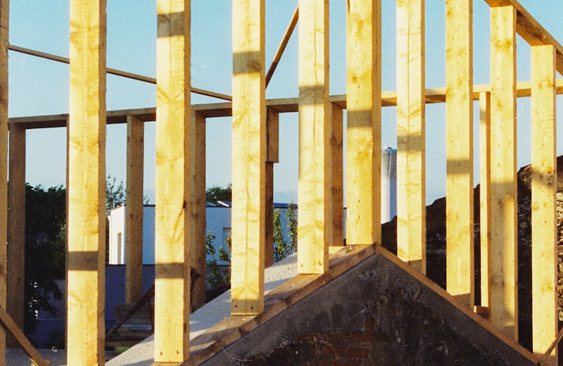 Wall framing rising from a brick foundation at golden hour