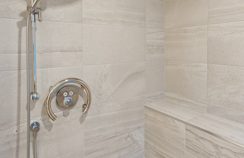 Tiled walk-in shower with a built-in seating bench