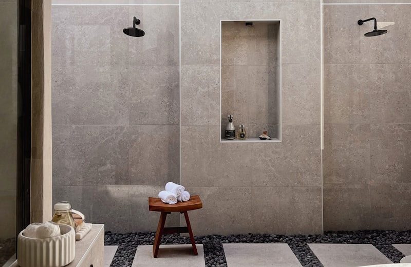Spa-style bathroom with a freestanding marble soaking tub and river-stone floor