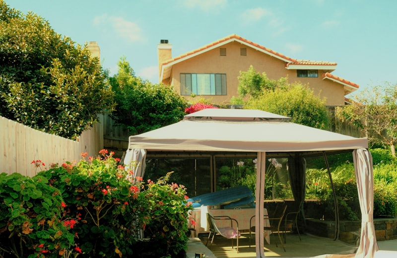 Mediterranean-style home with a backyard gazebo and patio seating