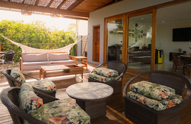 Covered outdoor living area with wicker furniture and a hammock