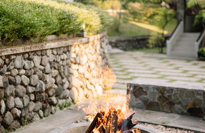 Stacked-stone fire pit with landscaped stone terracing
